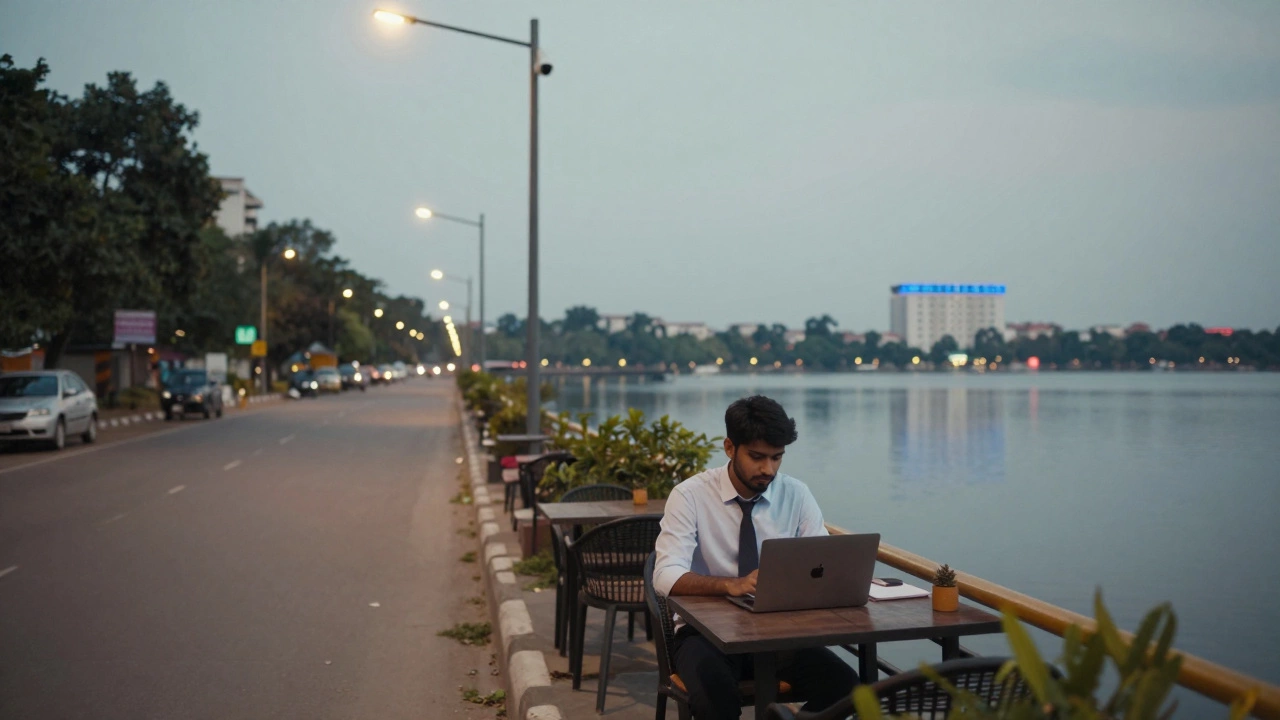 A professional works at a café by Hussain Sagar Lake in Hyderabad under safe, well-lit streets.