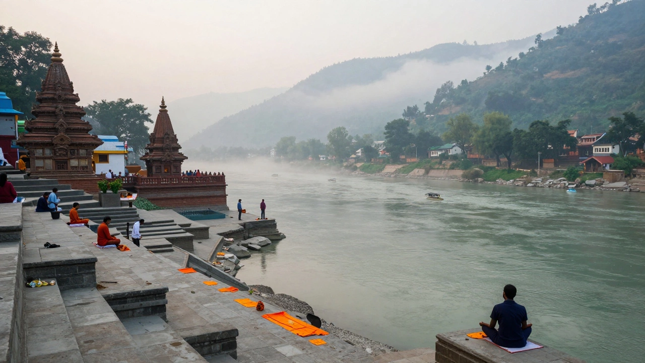 Rishikesh ghats on the Ganges at dawn with pilgrims and misty hills