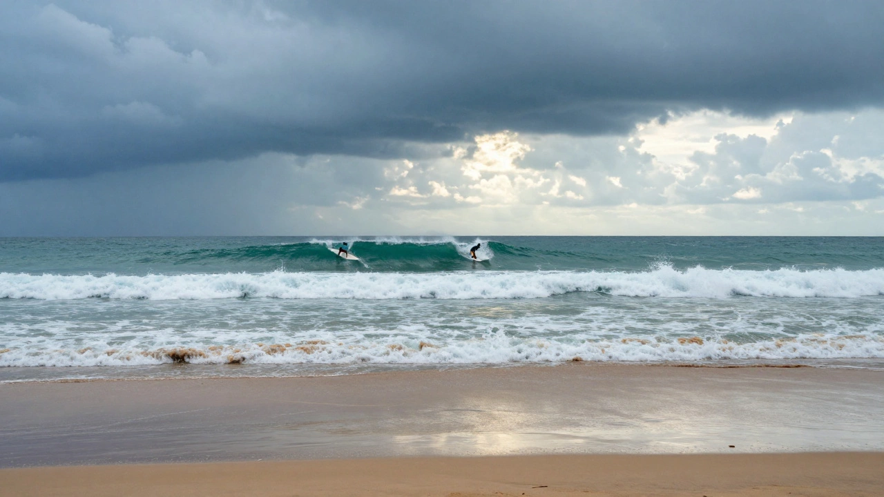 Surfer on empty Goa beach with storm clouds overhead